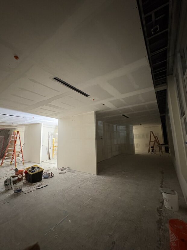 Drywall finished throughout the open showroom space